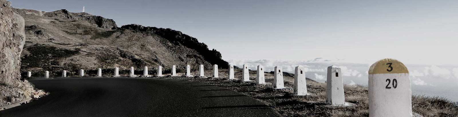 A road by the sea and mountains
