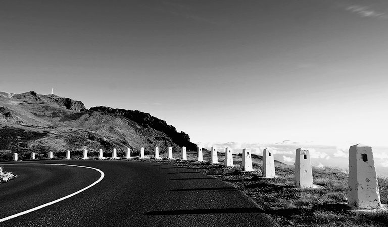 A road by the sea and mountains
