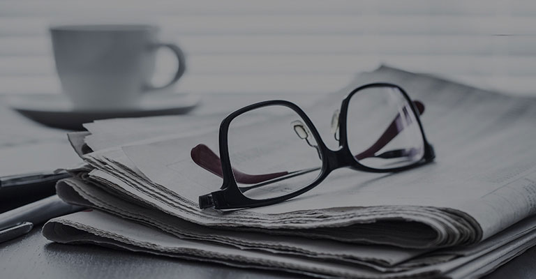 A pair of glasses on newspaper